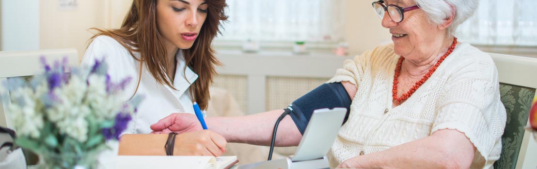 Student nurse writing notes on patient