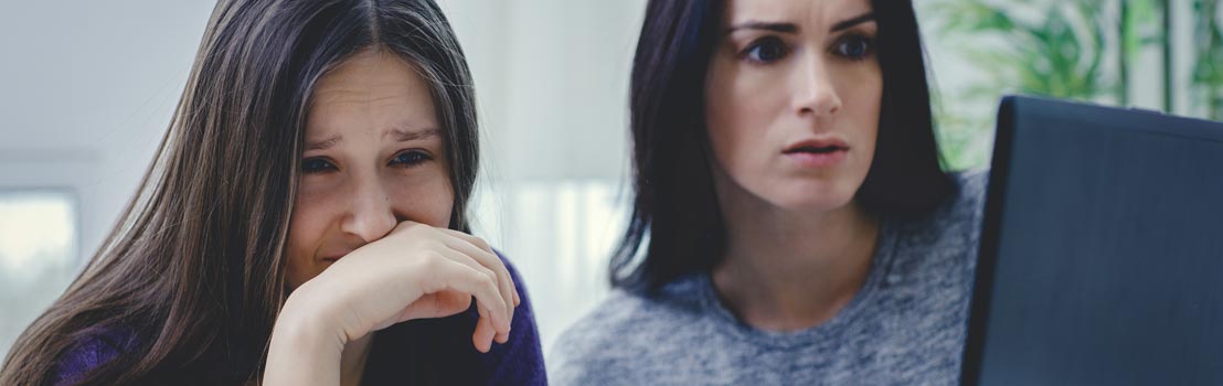 Mother and daughter looking at unsafe website