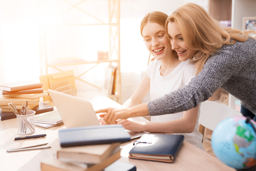 image of two friends pointing and sharing a computer screen