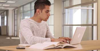 Male student working on his dissertation