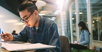 Male student working on his report